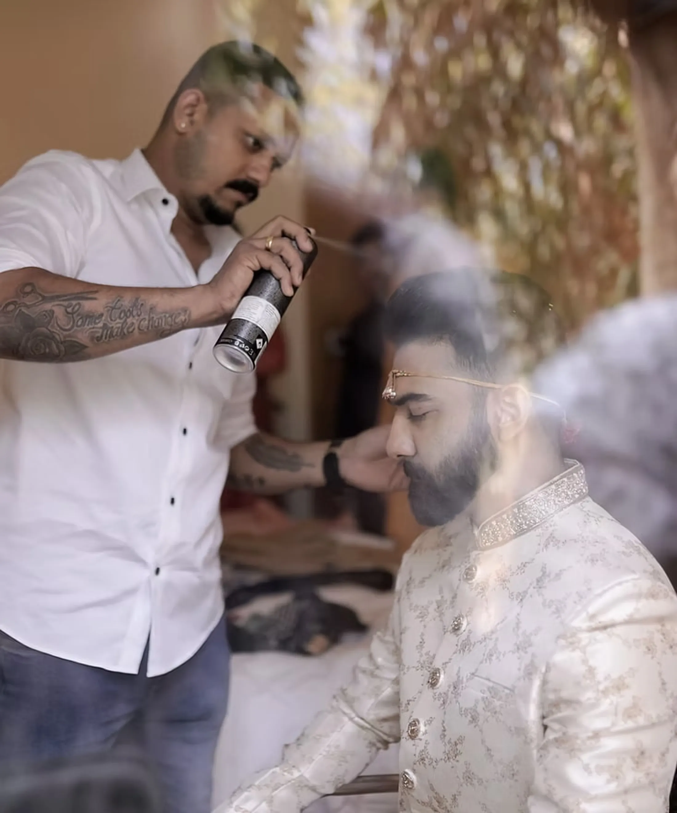 Sanju setting a groom’s hair before a wedding